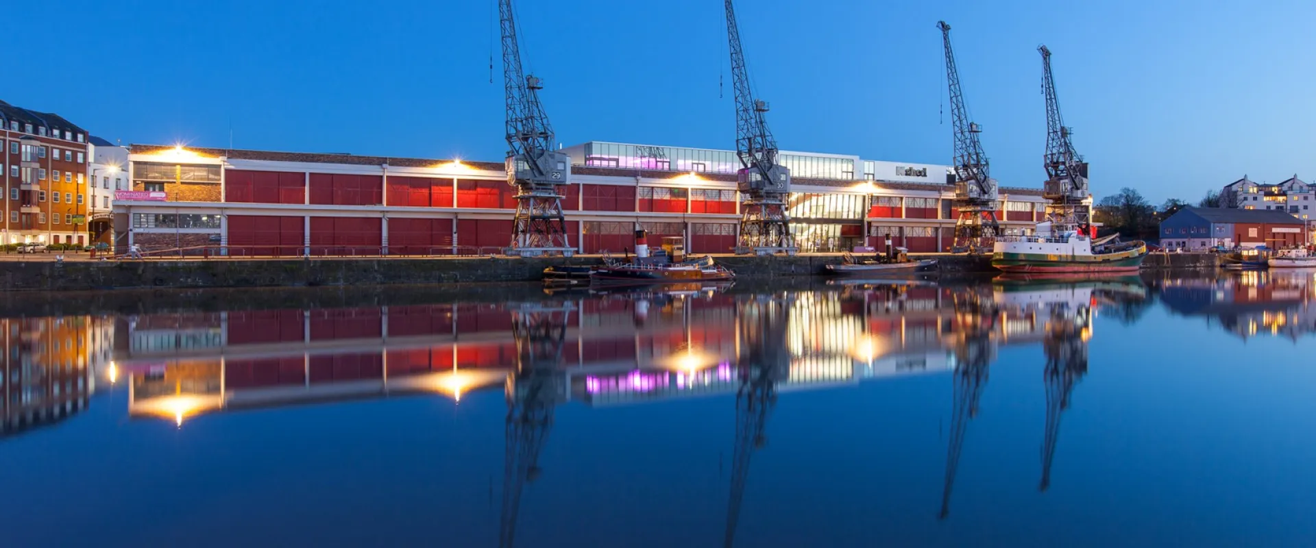 M Shed from water at night